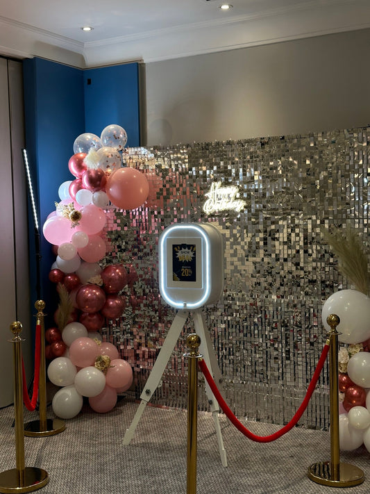 selfie booth with silver shimmer backdrop